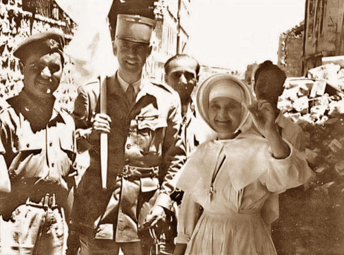 File:Sister of the St. Louis Hospital in Jerusalem holding up a denture recovered after having fallen out of the window into no-man's-land, 22 May 1956.jpg